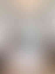 A cozy living room in The Byron hotel, featuring a piano and art-filled walls, exuding elegance and charm.