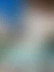 A serene pool area with two lounge chairs, a tray of orange slices and drinks, surrounded by white walls and clear blue skies at Casa del Rey Sabio, one of my favorite hotels with pool in Seville