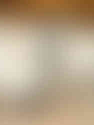 A stylish hotel room at St. Joseph's in Dubrovnik, featuring a bed, table with chairs, and an elegant chandelier.