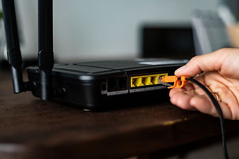 man-plugging-ethernet-cable-wireless-router.jpg