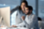 Two people looking at a computer screen together