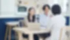 ouple consulting an interior designer in Singapore about affordable interior design options, discussing renovation plans at home.
