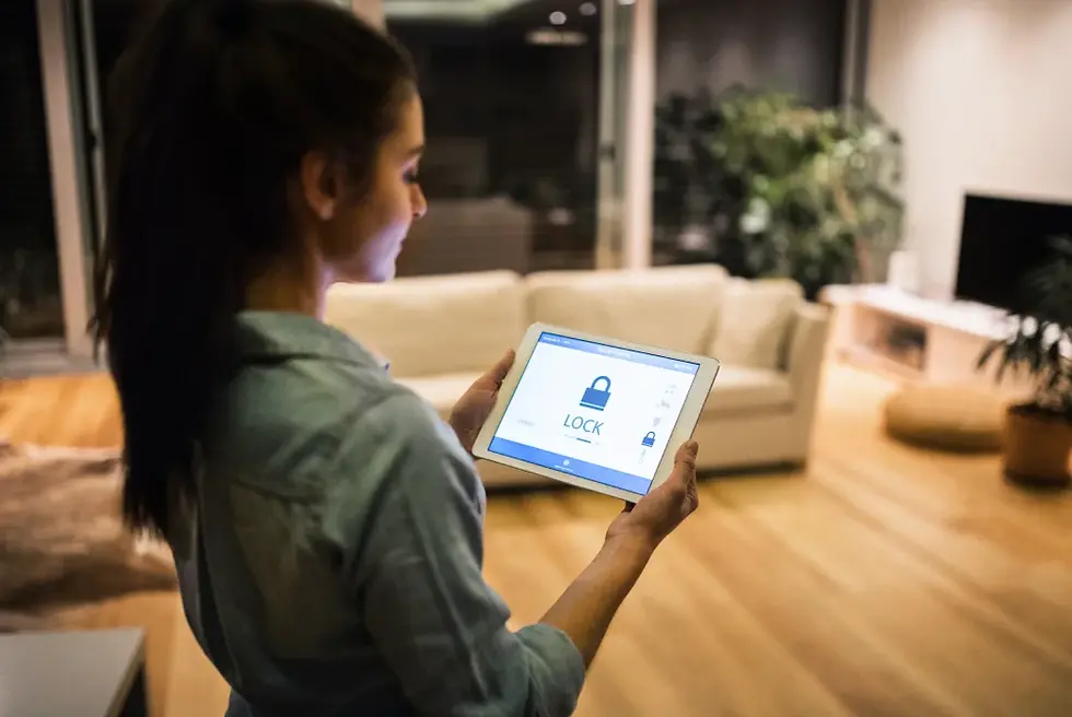 Woman using smart home tablet to control security system in a modern luxury interior design living room with wooden floors and contemporary furniture.