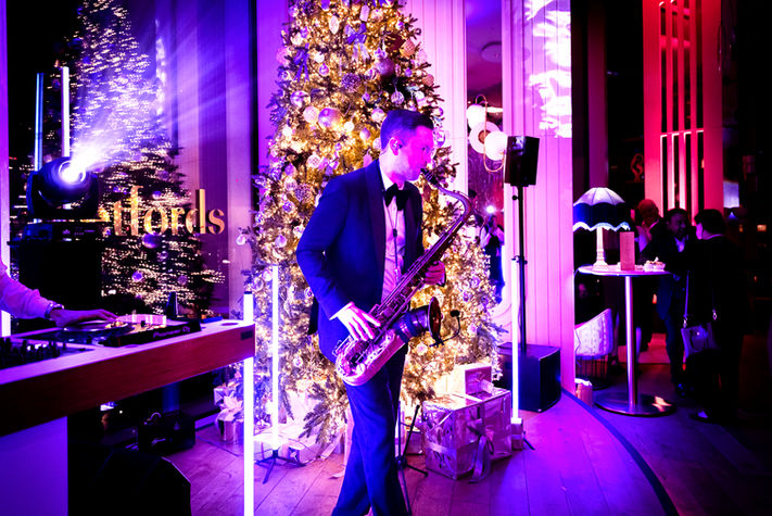 Man playing Saxophone at Corporate Christmas Party