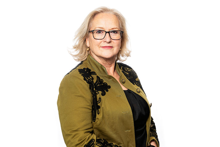business woman wearing glasses and a green jacket