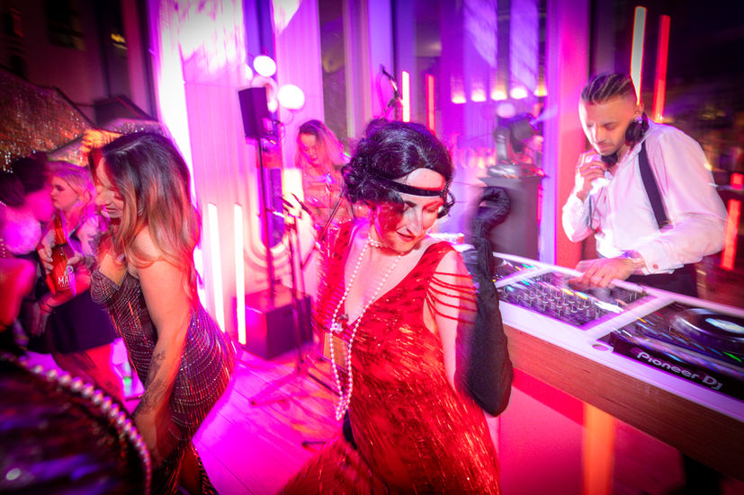 Woman Dancing in red dress on the dance floor in front of the DJ