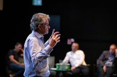 Business event photographer Sheffield capturing speaker at awards ceremony panel discussion
