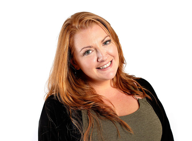 a woman with long red hair smiling