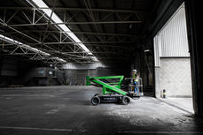 Industrial photographer Manchester capturing cherry picker in large industrial warehouse facility