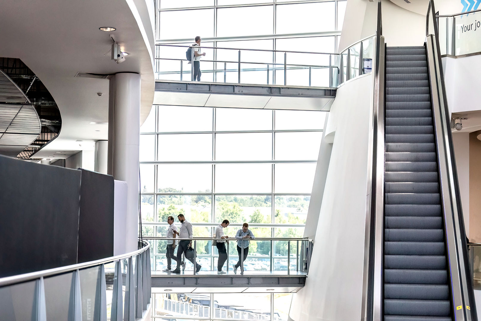 Modern commercial building interior in Manchester with people and escalators