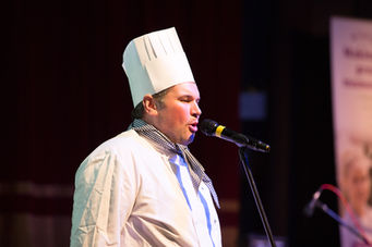 singing chef sings into a microphone