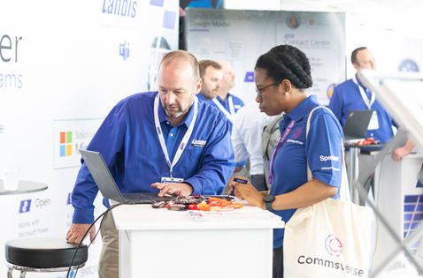 man and woman chatting at exhibition stand