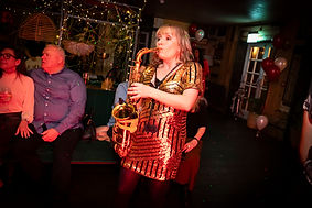 Woman playing saxophone at a corporate social event