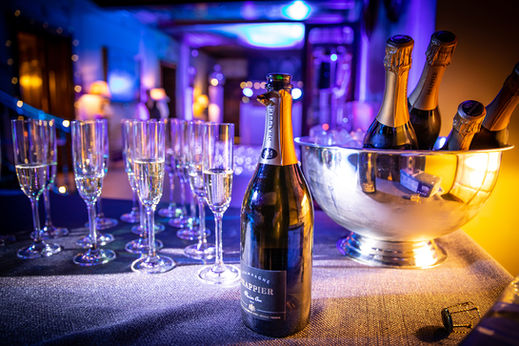 glasses and bottles of champagne at black tie event
