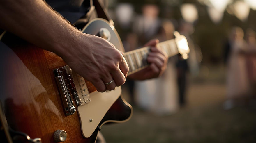 close up of man's hands playing electric guitar setting is outdoor wedding.jpg