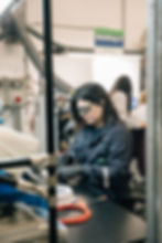 Woman working meticulously in a factory,