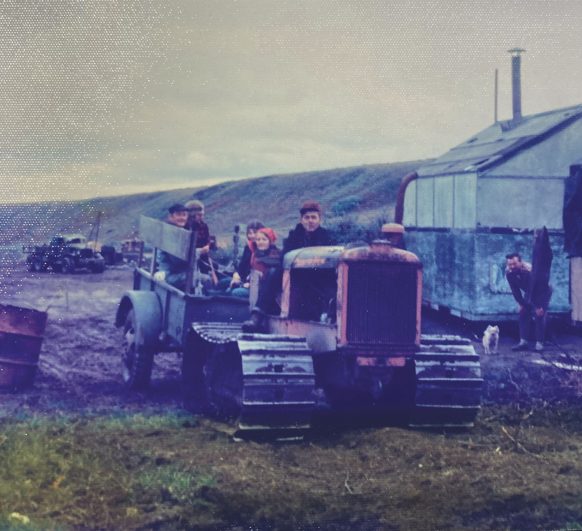 People standing around a tractor