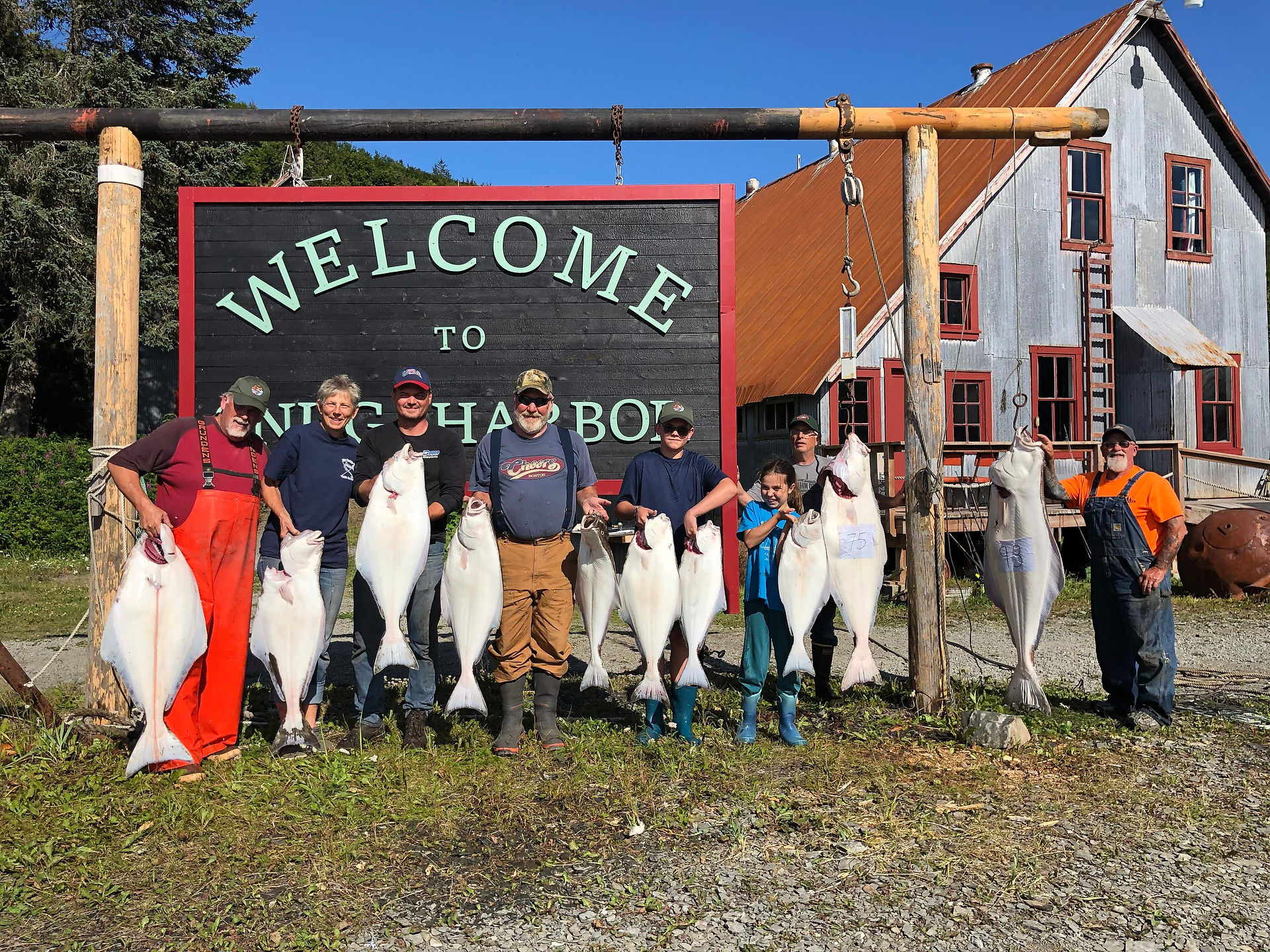 People standing in front of the welcome sign
