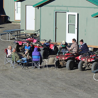 People sitting in chairs and four-wheelers