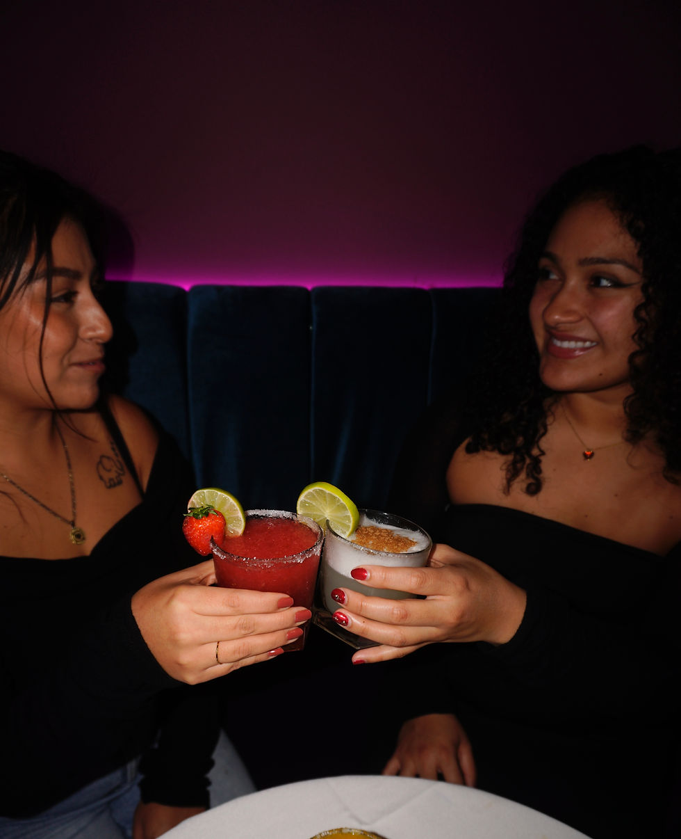 Close-up view of colorful Peruvian-Mexican fusion cocktails with chamoy rims