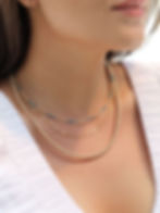 Woman wearing a delicate beaded necklace, gold filled jewelry