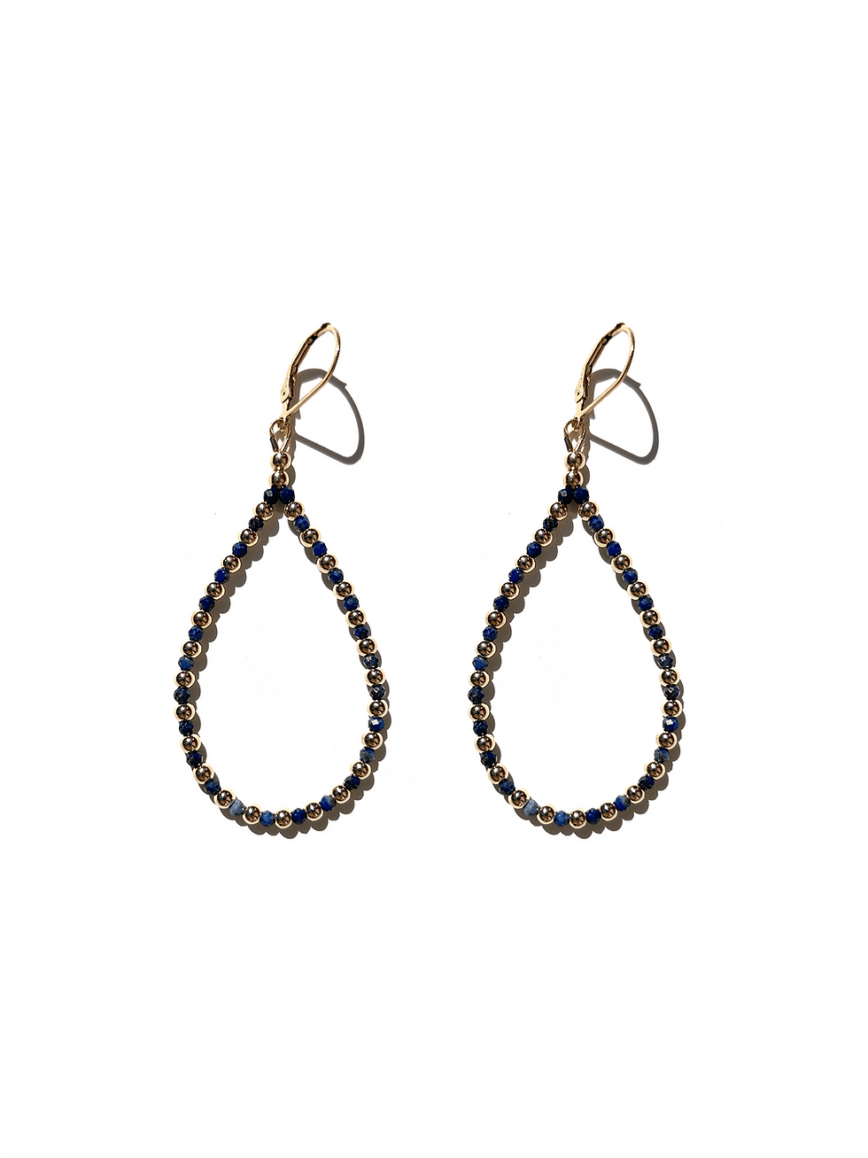 teardrop gemstone earrings on white background