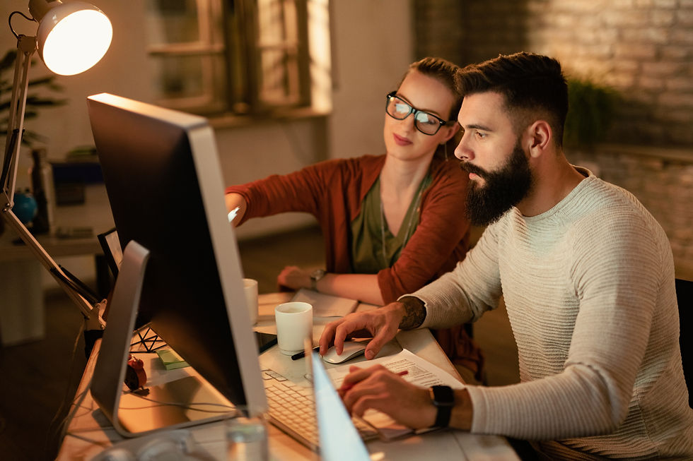 young-business-colleagues-using-computer-while-working-together-office.jpg