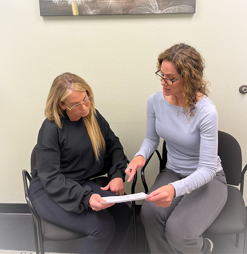 Carol Harmon speaks with a patioent at Core Functional Wellness