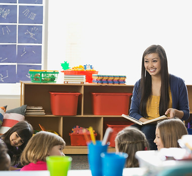 smiling-teacher-reading-to-students-in-elementary-2026-01-11-08-41-43-utc.jpg