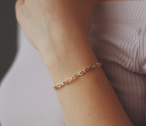 vertical-closeup-shot-female-wearing-golden-bracelet.jpg