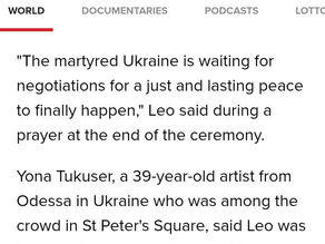 Yona Tukuser holds a "HOPE FOR PEACE" sign in St. Peter's Square at the Vatican during the Conclave