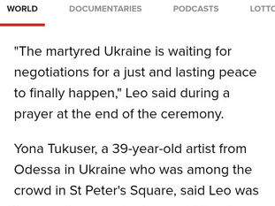 Yona Tukuser holds a "HOPE FOR PEACE" sign in St. Peter's Square at the Vatican during the Conclave