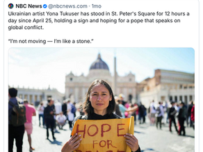 Yona Tukuser holds a "HOPE FOR PEACE" sign in St. Peter's Square at the Vatican during the Conclave