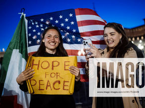 Yona Tukuser holds a "HOPE FOR PEACE" sign in St. Peter's Square at the Vatican during the Conclave