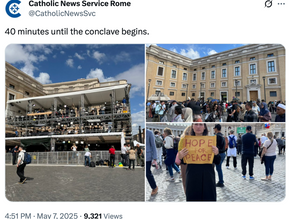 Yona Tukuser holds a "HOPE FOR PEACE" sign in St. Peter's Square at the Vatican during the Conclave