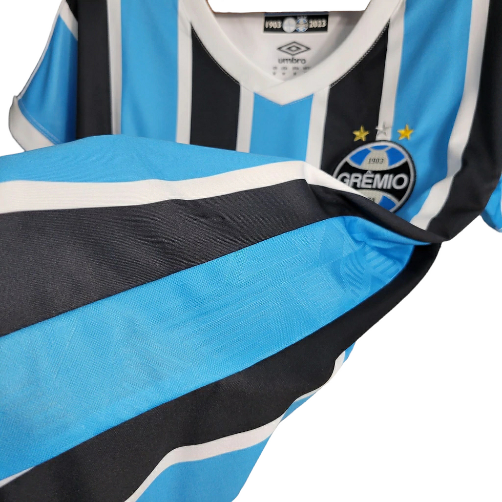 Miniatura: Camisa Grêmio I 23/24 - Torcedor Umbro Feminina - Azul com listras pretas e bran