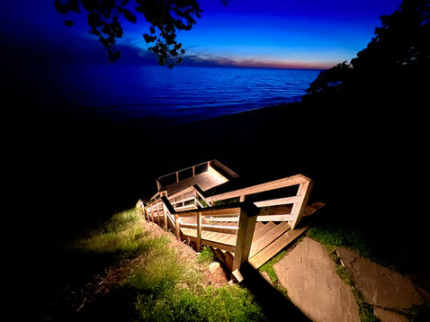 Integrated LED hardscape step lights built into a outdoor stairway for evening safety.