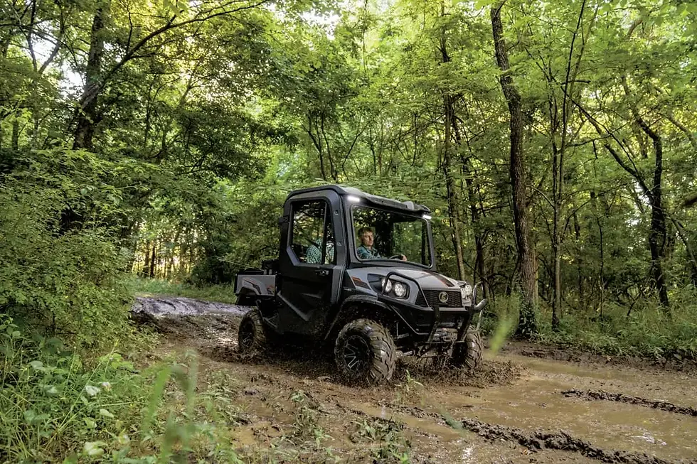 Kubota RTV-XG850 Sidekick utility vehicle with cab driving through a wooded trail — $0 Down 2.99% APR for 36 months at Glenn B. Dorning Inc. in Ontario, CA
