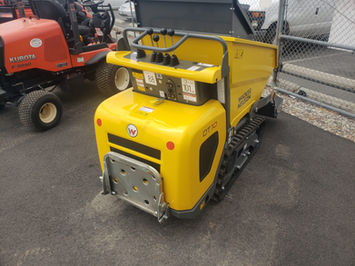 Wacker Neuson DT10 track dumper – front 3/4 view showing yellow dump body raised and compact machine profile
