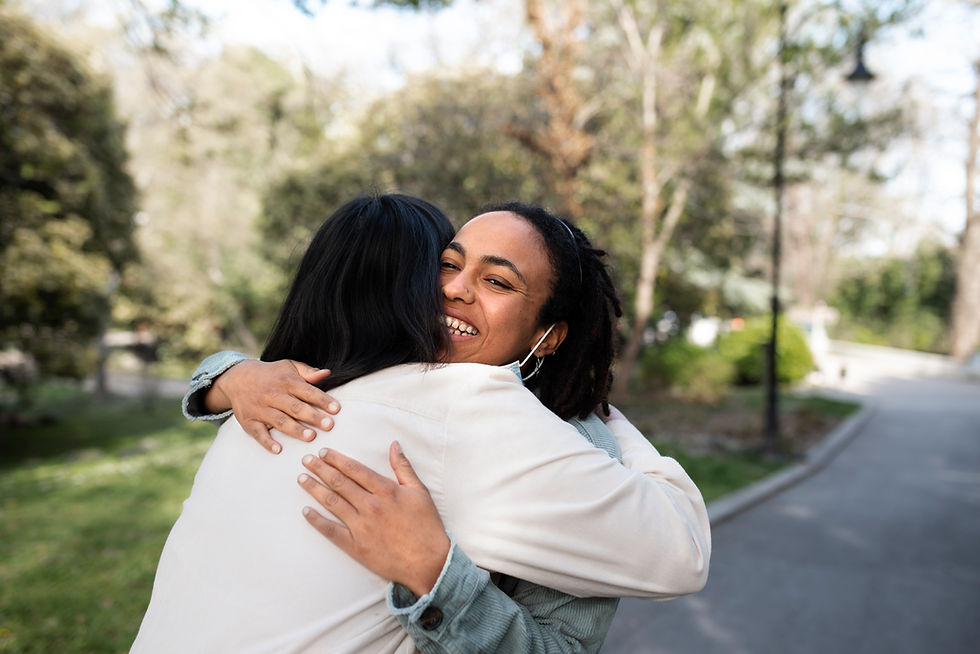 Two friends embracing outdoors, offering comfort and emotional support.