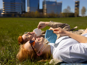 A woman sitting outside taking a quiet moment to herself — representing caregiver self-care and emotional reset.
