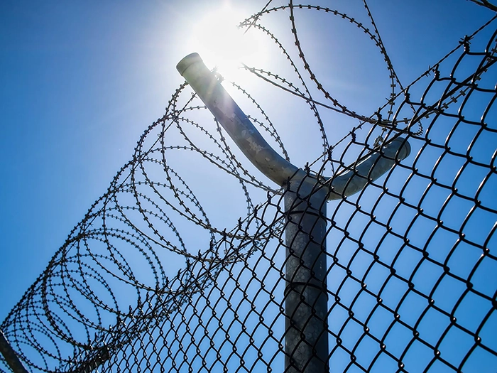 prison-journalism-concertina-fence-071623 (1).webp