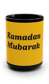 A 15oz black mug labelled with a golden yellow color background with "Ramadan Mubarak" statement written on it. In honor of Ramadan. Muslim fasting period.