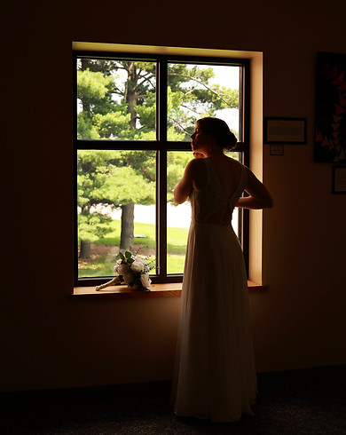 Image of a woman standing by a window