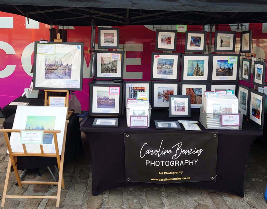 Caroline Benzies Photography market stall displaying limited edition Liverpool art prints