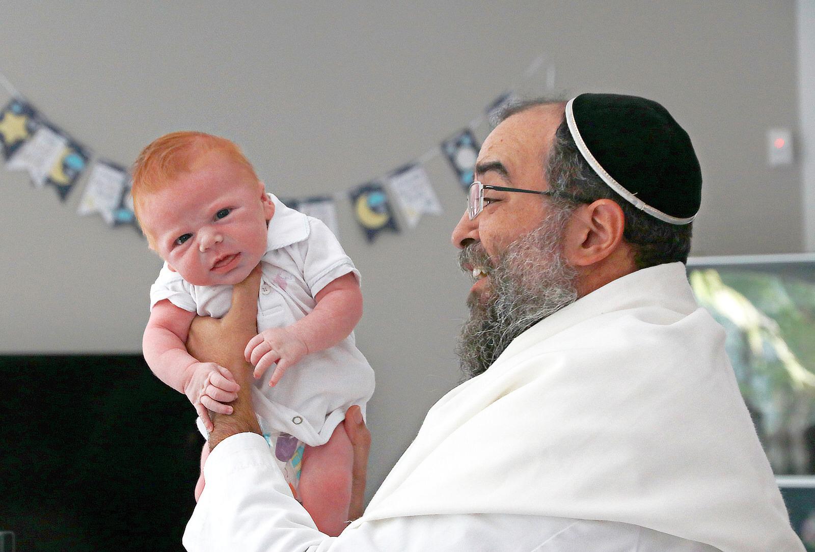 Rabbi Joseph with a newborn
