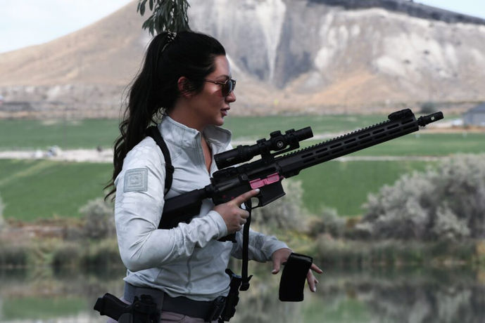 Women practicing safe gun handling techniques, wearing safety gear, and following strict protocols at Athena Tactics - Safety First: Responsible Firearm Use.