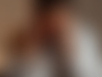 A stressed physician in scrubs sits alone at a cluttered hospital desk late at night, head resting in hands with eyes closed in exhaustion, surrounded by overflowing patient charts, a flickering computer screen, and an empty coffee mug—illustrating common burnout signs for healthcare professionals in 2025.