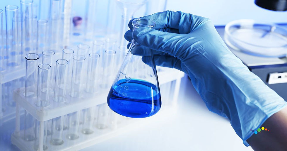 Gloved hand holds a flask with blue liquid in a lab. Test tubes are in the background, and the scene is lit with a cool blue tone.