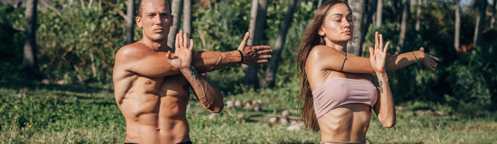 A beautiful male and female healthcare professional stretching in the morning sun, promoting stress relief and well-being. Keywords: healthcare professionals, stress relief, morning stretch, well-being.